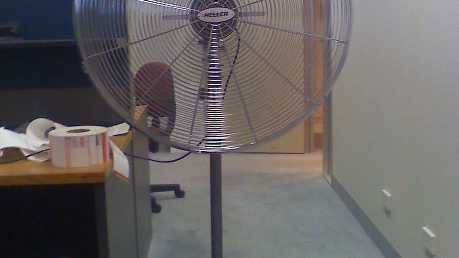 Tower fan style cooling in a bright office workspace